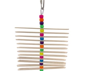 May include: A wooden bird toy with a chain and a string. The toy has 14 wooden slats and a colorful beaded string hanging from the chain.