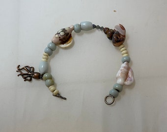 By the sea lampwork seshells and an octopus charm on a bracelet  PRICE REDUCTION