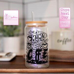 May include: A clear glass tumbler with a bamboo lid and a black and white graphic that says "Mama Needs Coffee". The tumbler has a built-in LED light that illuminates the graphic.