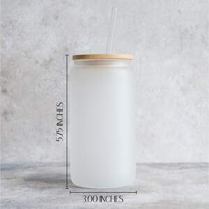 May include: A frosted glass tumbler with a bamboo lid and a clear drinking straw. The tumbler is 5.75 inches tall and 3 inches wide.