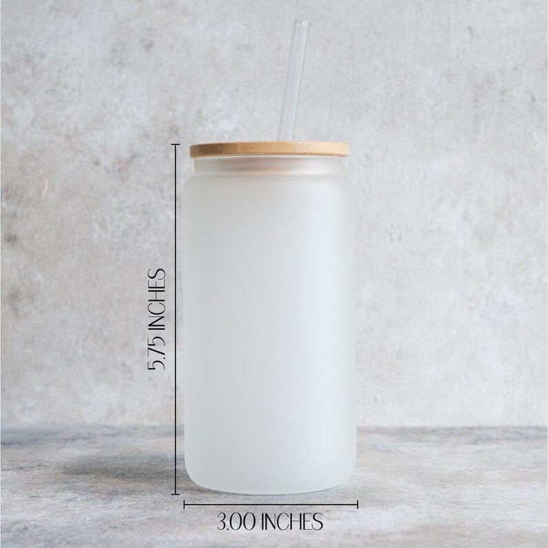 May include: A frosted glass tumbler with a bamboo lid and a clear drinking straw. The tumbler is 5.75 inches tall and 3 inches wide.