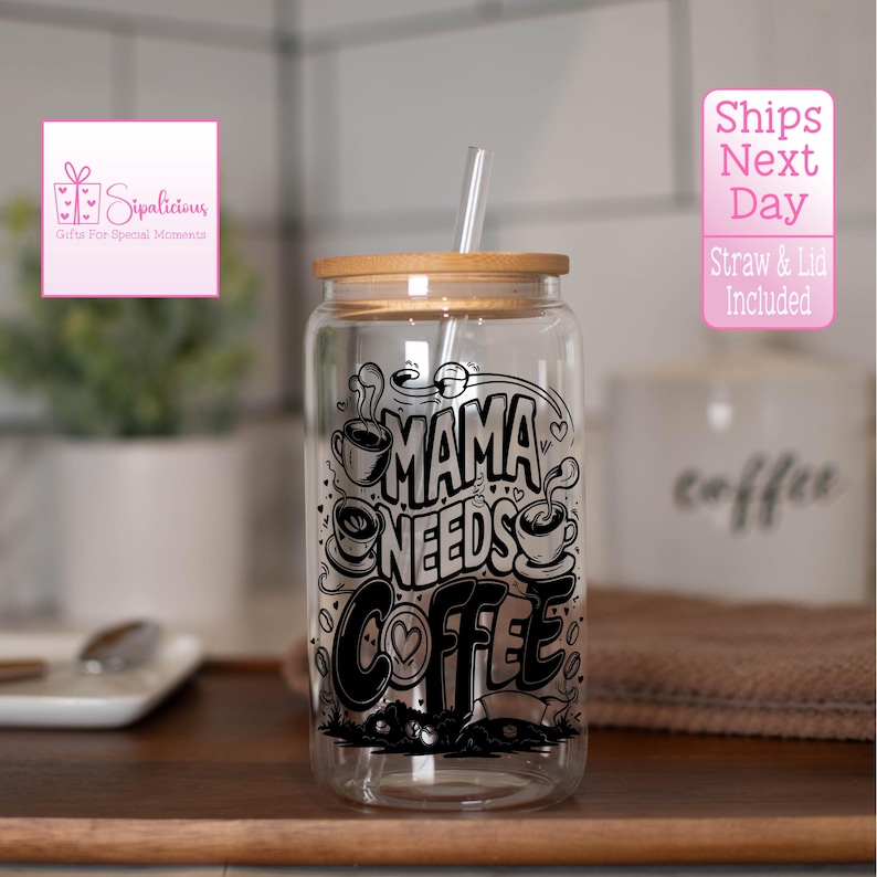May include: A clear glass tumbler with a bamboo lid and a black and white graphic that says "Mama Needs Coffee". The tumbler comes with a straw.