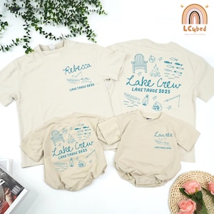 May include: Four beige t-shirts and rompers with blue graphics. Two adult t-shirts and two baby rompers feature lake-themed designs, including a boat, fishing rod, and the text "Lake Tahoe 2025". One shirt has the name "Rebecca".