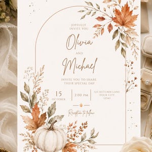 May include: A rectangular wedding invitation card featuring a thin copper-colored arch frame, watercolor illustrations of autumn leaves, berries, and a white pumpkin. The text reads: Joyfully invite you, Olivia and Michael, invite you to share their special day, 15 October, 2:00 PM, 123 Autumn Lane, Your City, 12345, Reception to follow.