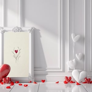 May include: A white framed picture with a heart-shaped floral design, red heart-shaped balloons, and scattered red rose petals. The scene is set against a white wall with decorative molding and a white floor.