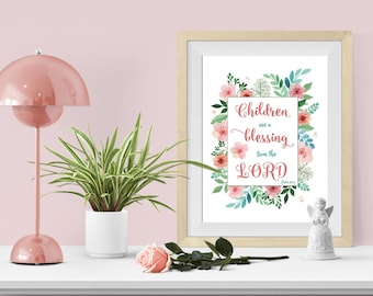 May include: Printable wall art with a floral design and the quote "Children are a blessing from the Lord" in pink and blue lettering. The quote is surrounded by pink and green flowers.