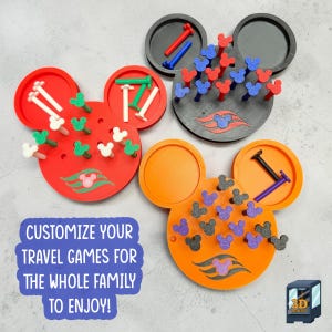 May include: Three Mickey Mouse-shaped peg games in red, black, and orange. Each board features circular storage areas and holes for colorful, glittery Mickey-shaped pegs. The text reads: CUSTOMIZE YOUR TRAVEL GAMES FOR THE WHOLE FAMILY TO ENJOY!