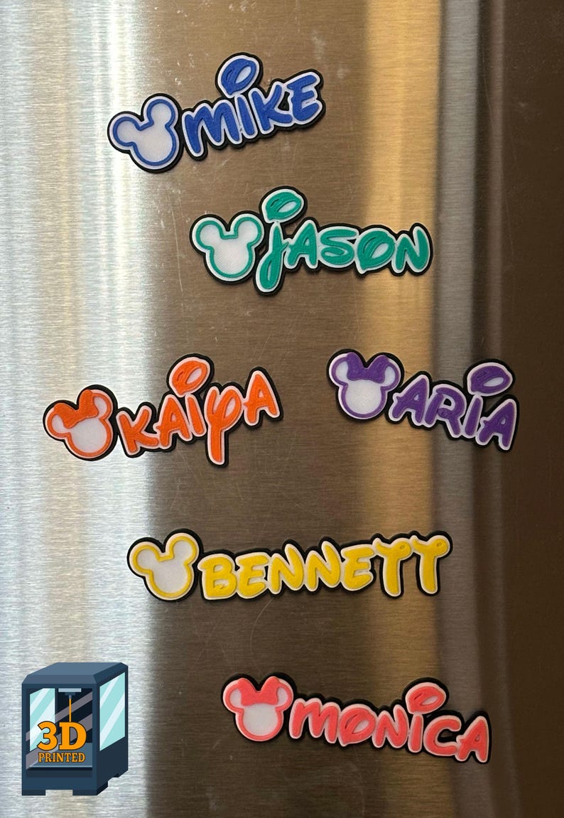 Six 3D printed name magnets examples with a Mouse head design. The magnets are in various colors including blue, green, orange, purple, yellow, and pink. Each magnet comes with a heavy duty magnet attached to the back with no overhang.