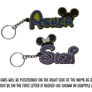 Two mouse inspired keychain examples.The boy version has the mouse head design on the right above the last letter in the name. The girl version has the mouse head with bow design on the left above the first letter of the name.