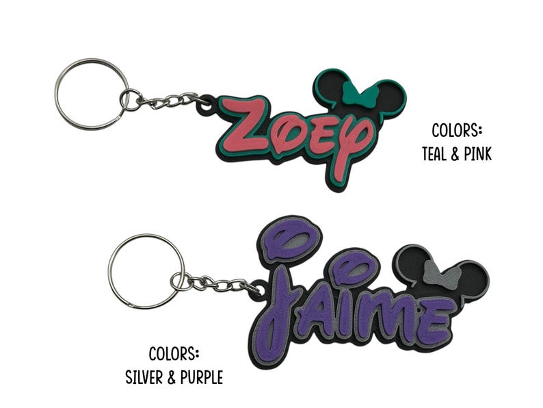 Two personalized keychains with a Mouse ear design with bow for girls. The first keychain is teal and pink with the name 'ZOEY' and the second keychain is silver and purple with the name 'JAIME'.