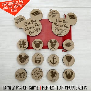 May include: Wooden family match game with Mickey Mouse-themed designs. The game includes large Mickey Mouse head-shaped pieces with text and smaller round pieces with various engraved images. The text "Can You Match All The?" is visible.