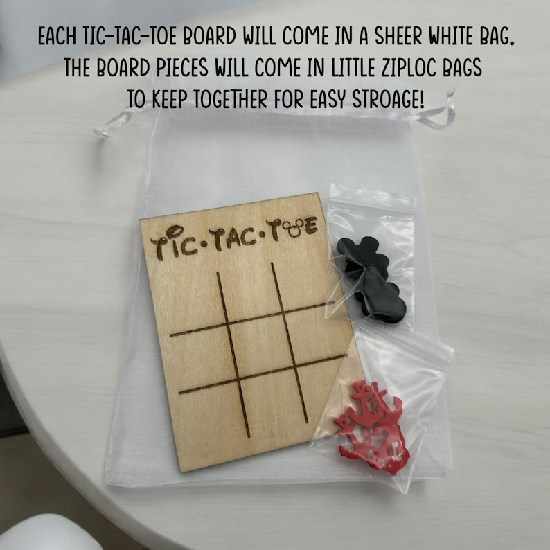 A wooden tic-tac-toe board with the words 'TIC-TAC-TOE' engraved on it. The board is in a clear sheer bag. There are two small bags of game pieces, one with black pieces and one with red pieces. The bags are also in clear plastic small bags for easy storage.