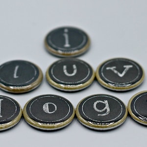 May include: Seven black and white round buttons with the letters "I LOVE DOGS" spelled out in white.