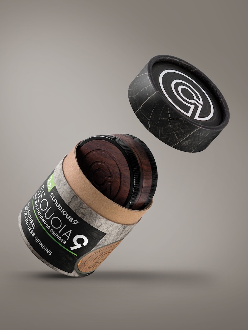 May include: A brown and black wooden grinder with the text "Cloudicous Sequoia 9 Natural Hardwood Grinder Wood-to-Herb Grinding" on the side. The grinder is in a cardboard tube with a black lid.