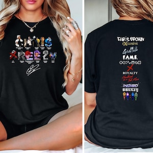 May include: Black t-shirt with a graphic design featuring Chris Brown's album covers and titles, including "Chris Brown", "Exclusive", "Graffiti", "F.A.M.E.", "X", "Royalty", "Heartbreak on a Full Moon", "Indigo", and "Breezy".
