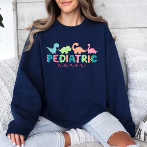 Pediatric Nurse Shirt: Colorful Dinosaur PEDS Nurse Hero Tee