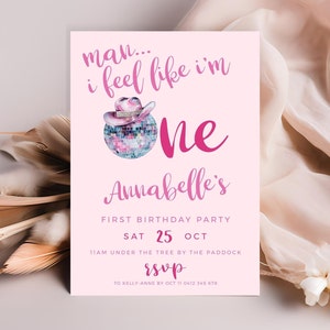 May include: Pink and white birthday party invitation with a disco ball and a pink cowboy hat. The text reads "man... i feel like i'm one Annabelle's First Birthday Party Sat 25 Oct 11am under the tree by the paddock rsvp to Kelly-Anne by Oct 11 0412 345 678"