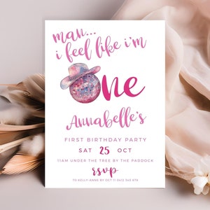 May include: Pink and white birthday party invitation with a disco ball wearing a cowboy hat. The text reads "man... i feel like i'm one Annabelle's First Birthday Party Sat 25 Oct 11am under the tree by the paddock rsvp to Kelly Anne by Oct 11 0412 345 678"