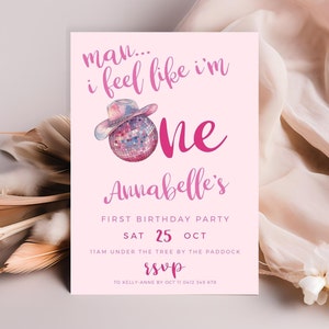 May include: Pink birthday party invitation with the text "man... I feel like I'm one Annabelle's First Birthday Party". The invitation features a watercolor illustration of a disco ball wearing a cowboy hat.