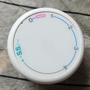 Può includere: Un quadrante bianco e circolare con numeri e segni. I numeri da 0 a 4 sono visualizzati attorno al bordo, collegati da una linea blu. Il quadrante presenta anche il testo ".S.S."