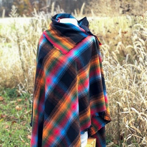 Fabric poncho on a bust for display, Black Cotton Rainbow Plaid with Cowl Collar and Fringe