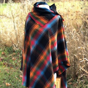 Fabric poncho on a bust for display, Black Cotton Rainbow Plaid with Cowl Collar and Fringe