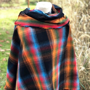 Fabric poncho on a bust for display, Black Cotton Rainbow Plaid with Cowl Collar and Fringe