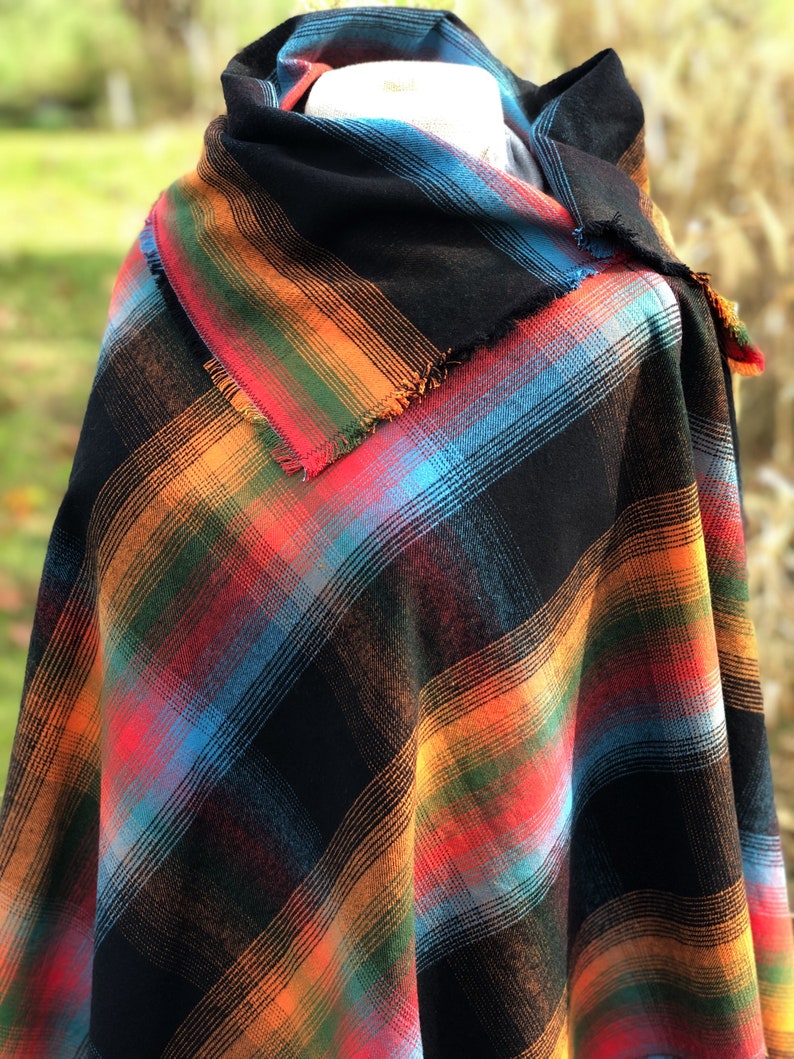 Fabric poncho on a bust for display, Black Cotton Rainbow Plaid with Cowl Collar and Fringe