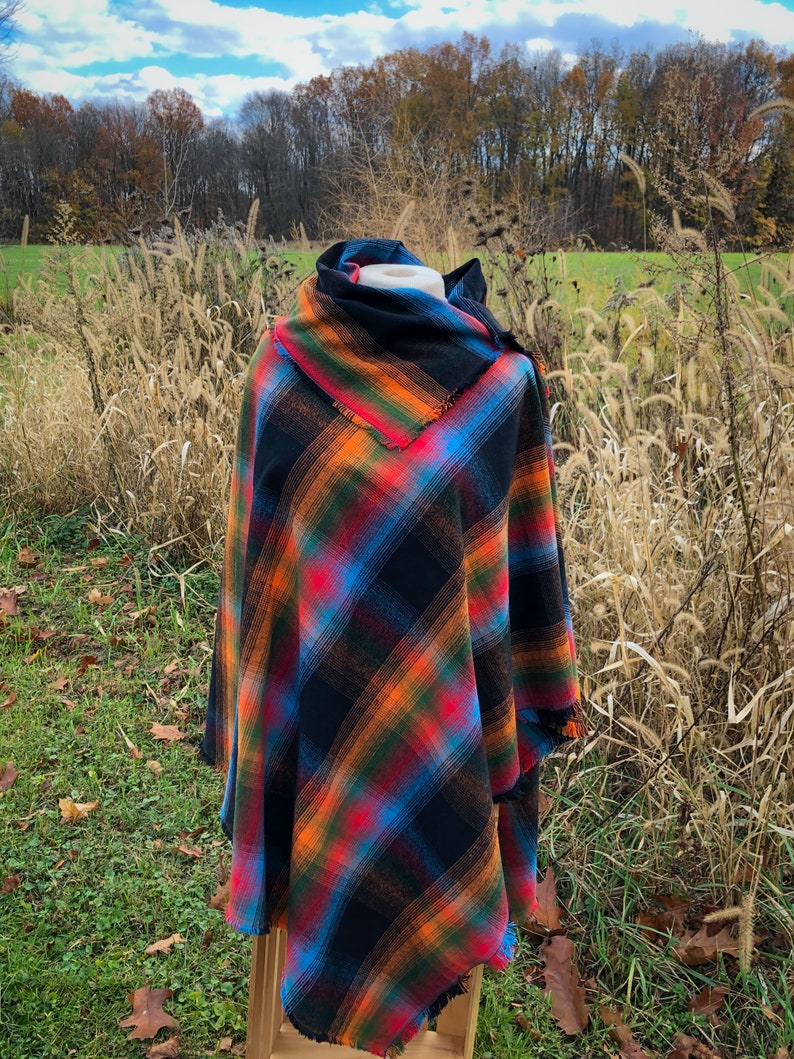 Fabric poncho on a bust for display, Black Cotton Rainbow Plaid with Cowl Collar and Fringe