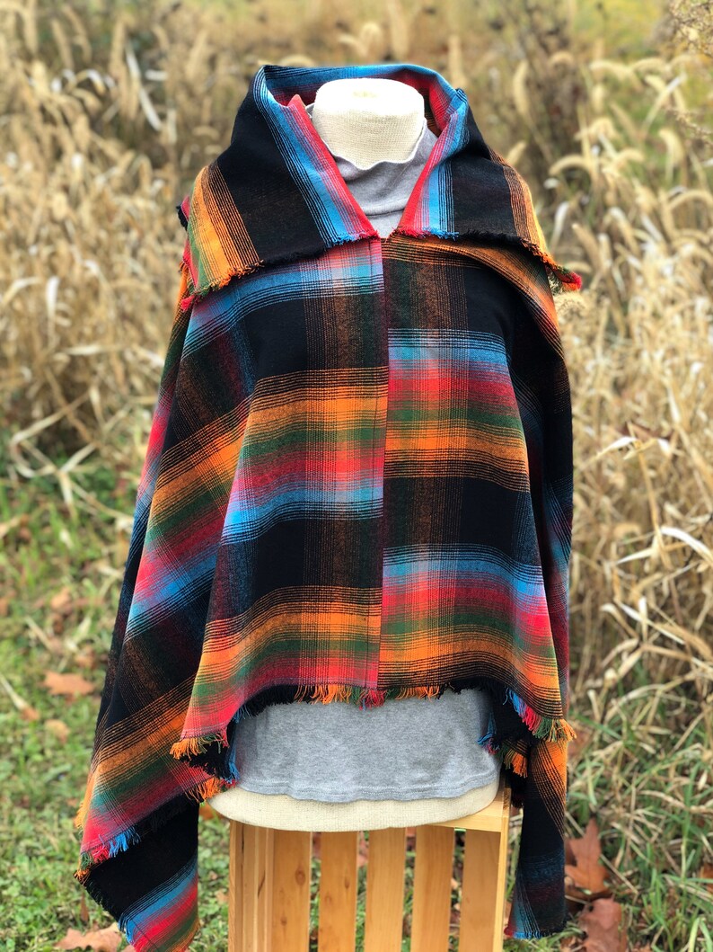 Fabric poncho on a bust for display, Black Cotton Rainbow Plaid with Cowl Collar and Fringe