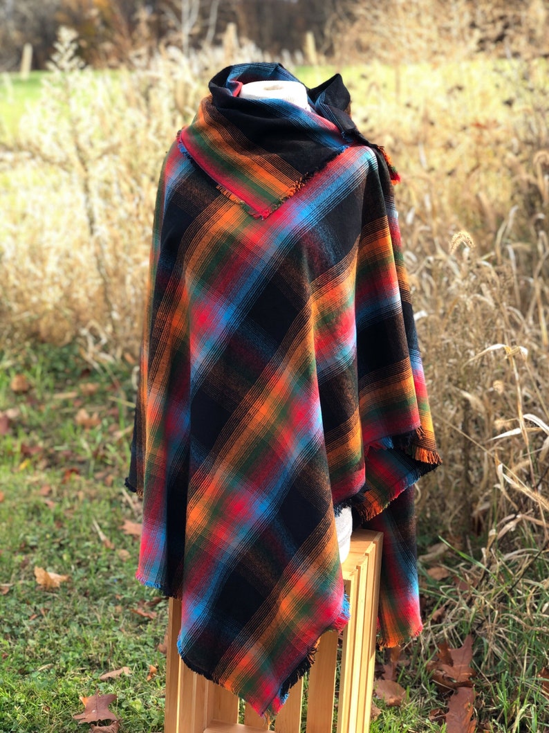 Fabric poncho on a bust for display, Black Cotton Rainbow Plaid with Cowl Collar and Fringe