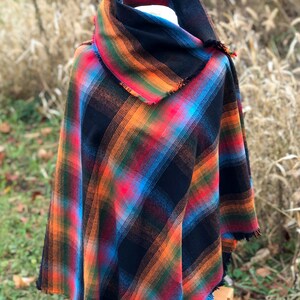 Fabric poncho on a bust for display, Black Cotton Rainbow Plaid with Cowl Collar and Fringe