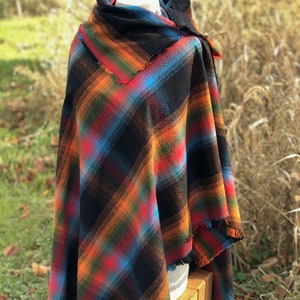 Fabric poncho on a bust for display, Black Cotton Rainbow Plaid with Cowl Collar and Fringe