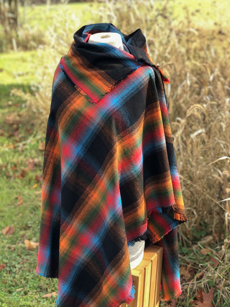 Fabric poncho on a bust for display, Black Cotton Rainbow Plaid with Cowl Collar and Fringe