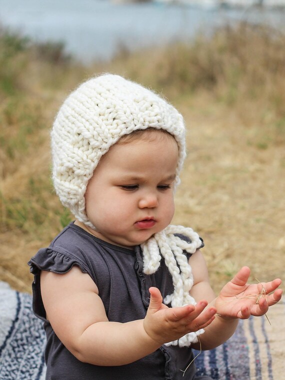 white knitted baby bonnet