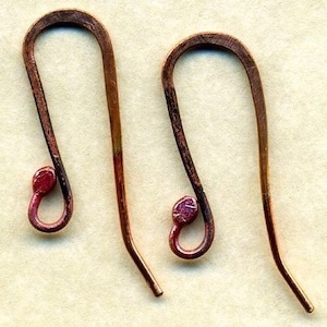 May include: A pair of copper wire earring hooks with a red-brown patina. The hooks are open and have a small loop at the top.
