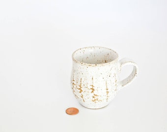 White ceramic coffee cup or tea cup with snowy forest scene textured clay handmade  wheel thrown glossy glazes