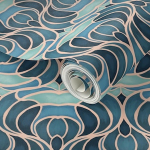 May include: A roll of wallpaper featuring an abstract design in shades of teal, blue, and blush pink. The pattern consists of flowing, organic shapes with a painted appearance. The wallpaper is partially unrolled, revealing the pattern.
