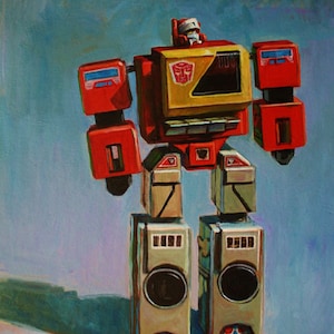 May include: A red, yellow, and gray robot toy with a cassette player design. The robot has a large head with a yellow face and a red Autobot symbol. The robot is standing on a blue background.