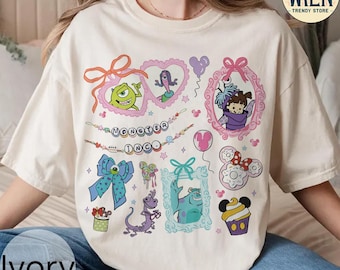 May include: A white t-shirt with a colorful graphic print of characters from the movie Monsters Inc. The graphic includes Sully, Mike, Boo, and other characters from the movie. The shirt has a crew neck and short sleeves.