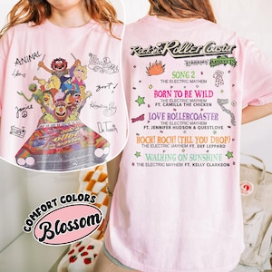 May include: Pale pink t-shirt with a graphic of the Muppets on a roller coaster, with text including "Rockin' Roller Coaster" and song titles. The shirt also has the words "Comfort Colors" and "Blossom".