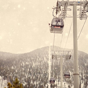 a ski lift going up a snowy mountain