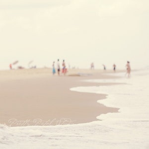 people in the distance of a sandy beach