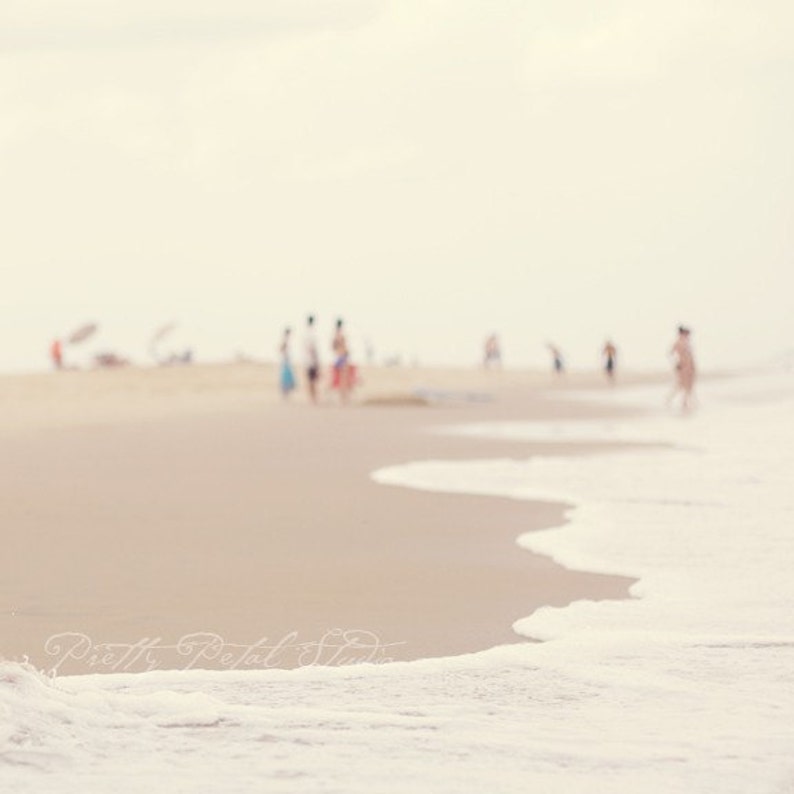 people in the distance of a sandy beach