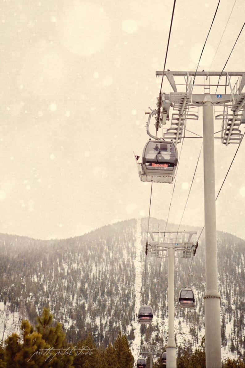 a ski lift going up a snowy mountain