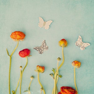 a group of flowers and butterflies on a blue background