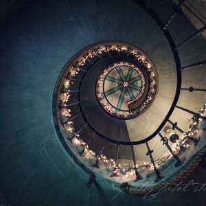 a spiral staircase with christmas lights on it