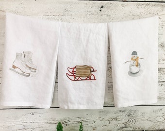 Winter themed French linen tea towels, art by Emma Pyle, set of three, vintage skates, vintage sled, snowman art by Canadian artist