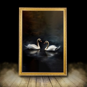 May include: A framed painting depicts two white swans on a dark, reflective body of water. The swans have orange beaks and are set against a moody, dark background. The ornate gold frame adds a classic touch to the artwork.