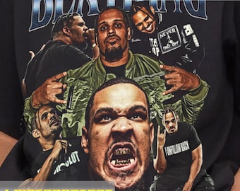 May include: Black t-shirt with a graphic print of multiple men. The text "BEATING" is printed in blue and white letters across the top of the shirt. The men in the graphic are wearing various clothing, including a green jacket, a black shirt with the text "I UNFOLLOW BACK", and a black shirt with the text "NEVER FALL OFF".
